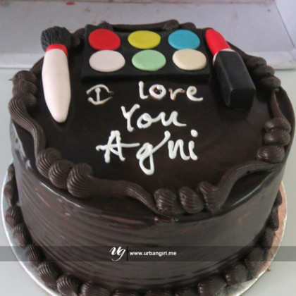 "ChocoGlam Cake: Indulge in delectable chocolate goodness topped with a trendy and fun makeup kit!"
