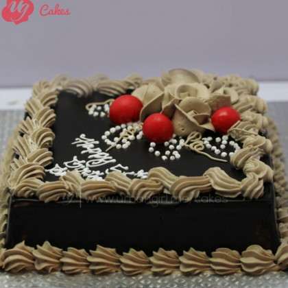 Decadent Chocolate Cake with Caramel Drizzle and Fresh Cherry Garnish