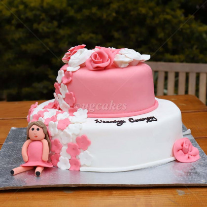 Double Decker Pink and White Cake with a Lady Resting on it