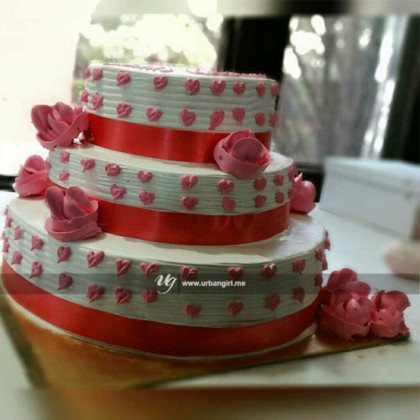 Delicate Delights: Triple Decker Wedding Cake adorned with Pink Roses