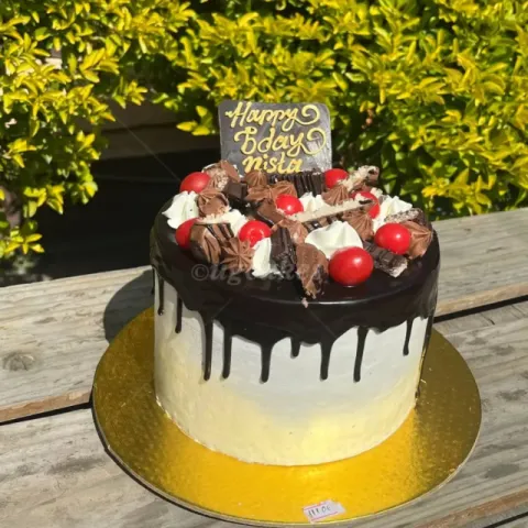 Chocolate cake with cherry toppings and chocolates